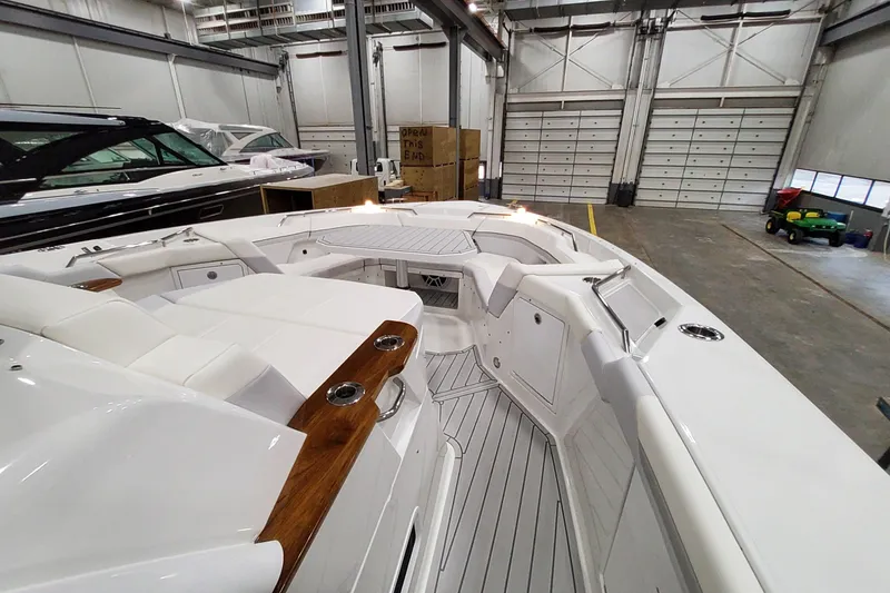 Slide: The Image of 2026 Formula 457 Center Console Fish boat interior in a spacious warehouse setting. - 24