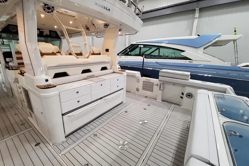 Slide: The Image of 2026 Formula 457 Center Console Fish boat interior with seating and storage. - 34