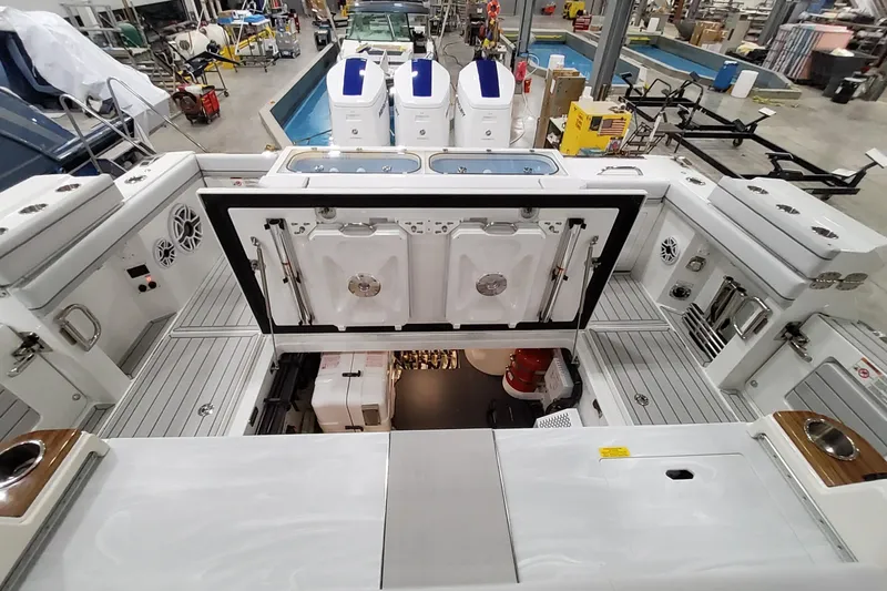 Slide: The Image of 2026 Formula 457 Center Console Fish boat interior with open hatch, showcasing storage and equipment. - 42