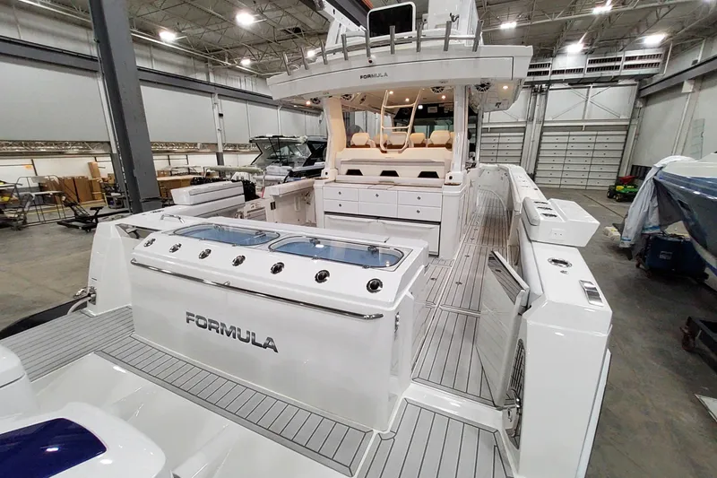 Slide: The Image of 2026 Formula 457 Center Console Fish boat in a spacious indoor showroom. - 50