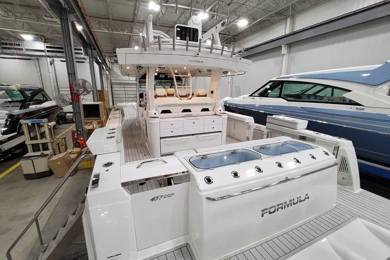 Slide: The Image of 2026 Formula 457 Center Console Fish boat in a showroom, showcasing sleek design and features. - 51