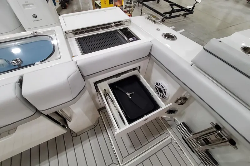 Slide: The Image of 2026 Formula 457 Center Console Fish boat interior with storage and grill features. - 52