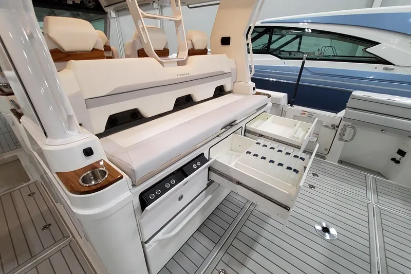Slide: The Image of 2026 Formula 457 Center Console Fish boat with open storage drawers and seating area. - 54