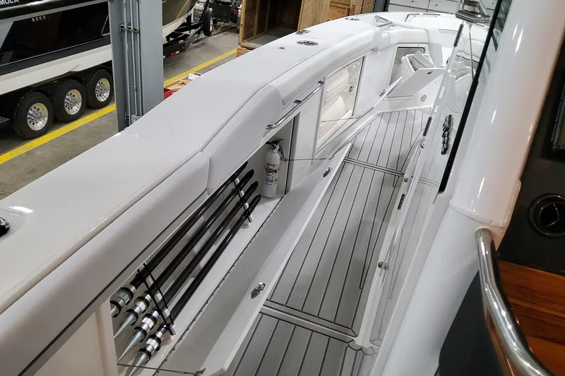 Slide: The Image of 2026 Formula 457 Center Console Fish boat interior with sleek design and rod storage. - 61