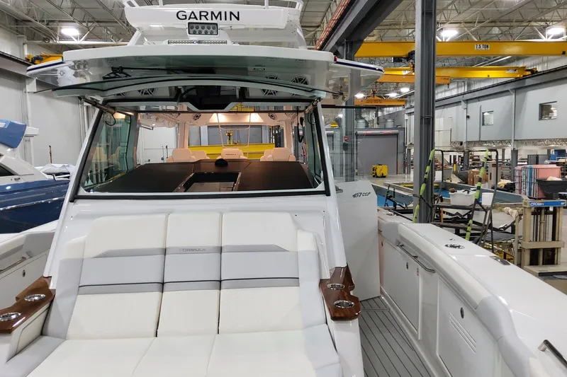 Slide: The Image of 2026 Formula 457 Center Console Fish boat in a workshop, featuring Garmin equipment. - 67