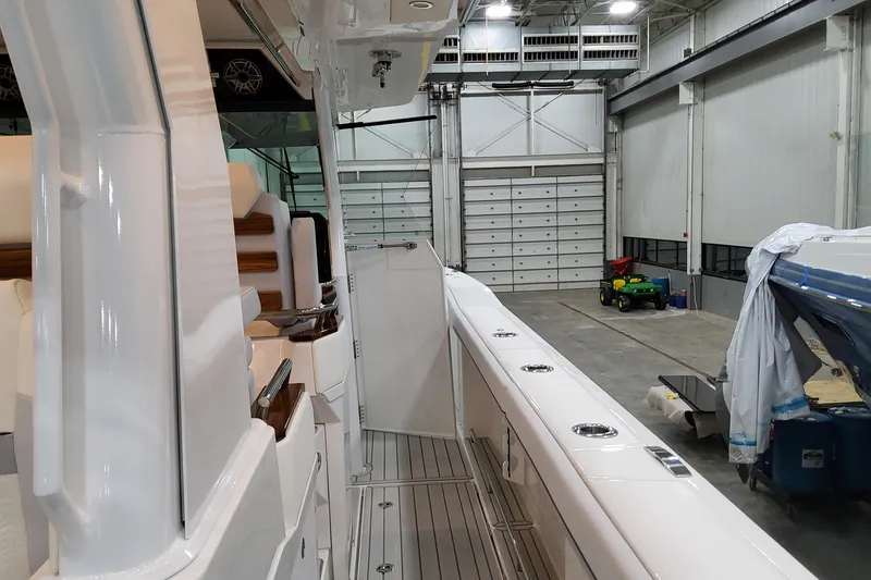 Slide: The Image of 2026 Formula 457 Center Console Fish boat interior in a spacious warehouse. - 68