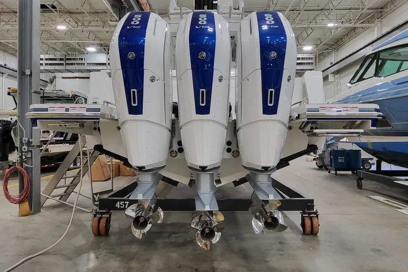Slide: The Image of 2026 Formula 457 Center Console Fish with triple 600 V12 outboard engines in a workshop. - 75