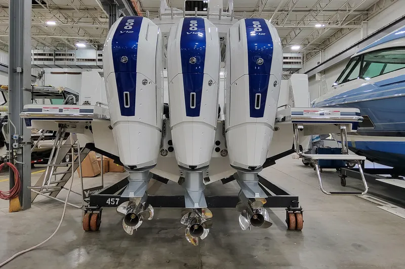 Slide: The Image of 2026 Formula 457 Center Console Fish with triple 600 V12 outboard engines in a showroom. - 77