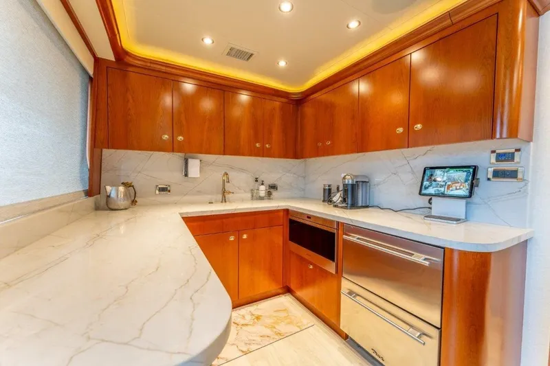 Slide: The Image of Luxurious kitchen interior on 2006 Westport 130 Motoryacht with marble countertops and wooden cabinets. - 30