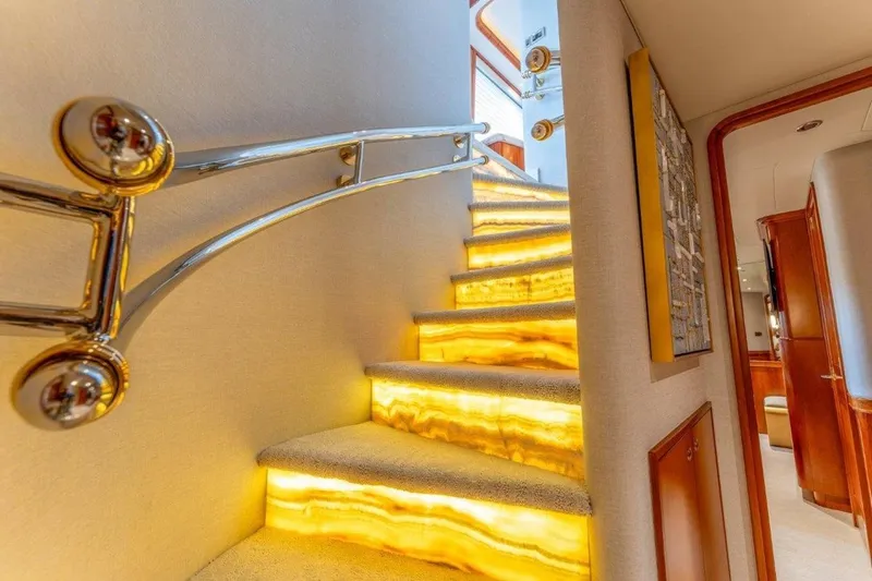Slide: The Image of Luxurious illuminated staircase inside 2006 Westport 130 Motoryacht, featuring elegant design and modern decor. - 33