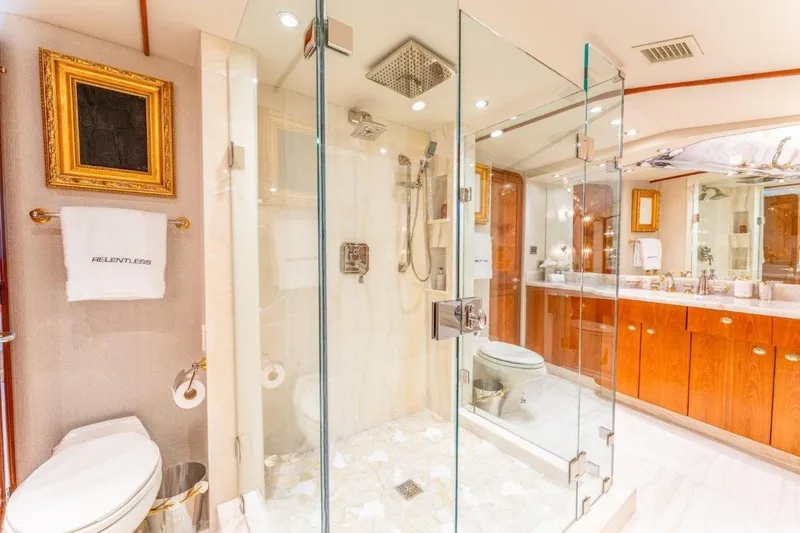 Slide: The Image of Luxurious bathroom on 2006 Westport 130 Motoryacht with glass shower and elegant wood cabinetry. - 38