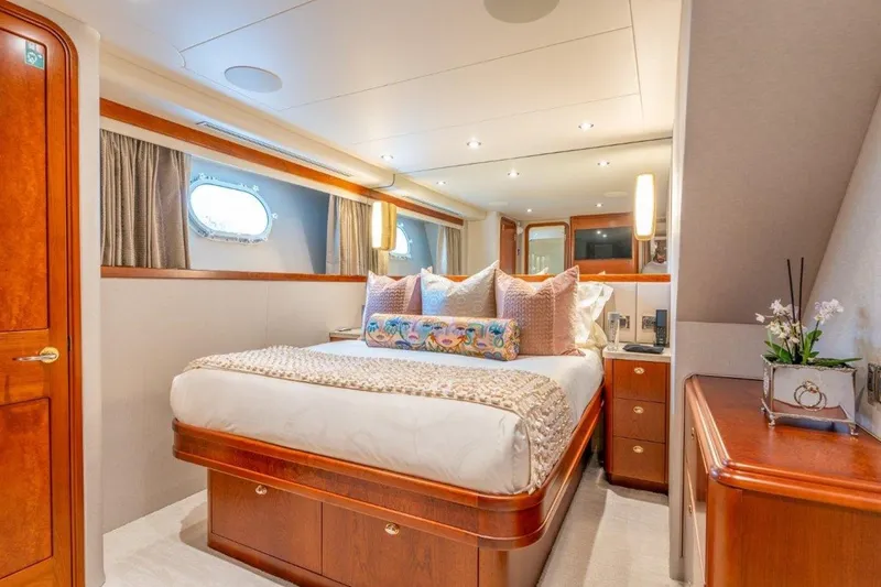 Slide: The Image of Luxurious bedroom interior of 2006 Westport 130 Motoryacht with elegant wood finishes and plush bedding. - 42