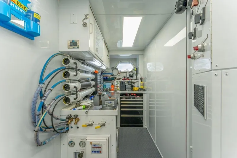 Slide: The Image of Engine room of 2006 Westport 130 Motoryacht with control panels and equipment. - 49