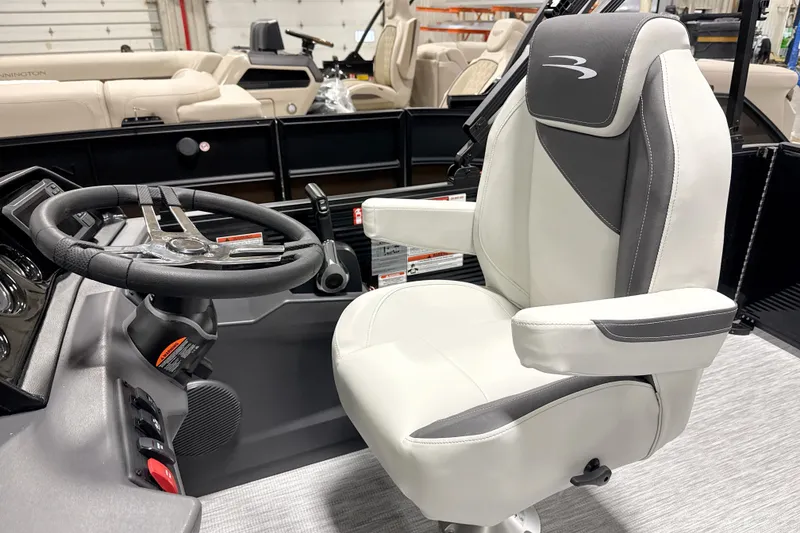 Slide: The Image of Captain's chair and steering wheel of 2026 Bennington 22 S1 Swingback boat interior. - 11