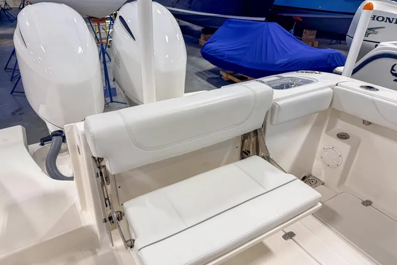 Slide: The Image of 2023 Pursuit S 268 Sport boat interior with white seating and dual engines. - 4