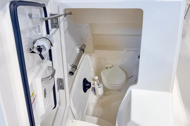 Slide: The Image of 2023 Pursuit S 268 Sport boat interior with compact marine toilet. - 8
