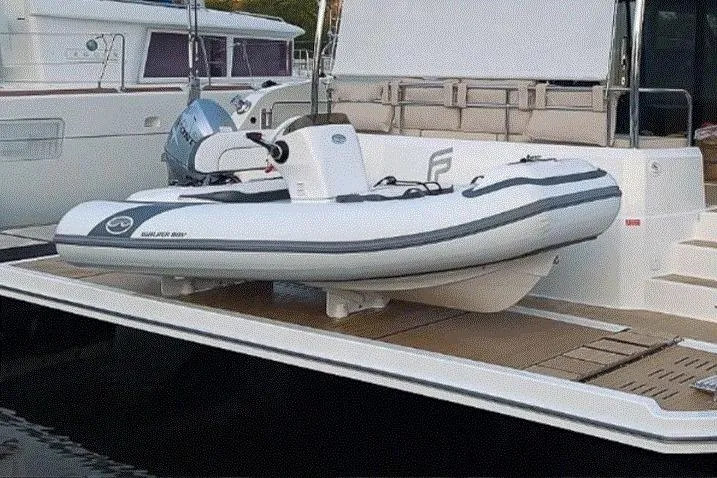 Slide: The Image of Walker Bay Generation 12 LTE 2025 inflatable boat docked on a yacht platform. - 4