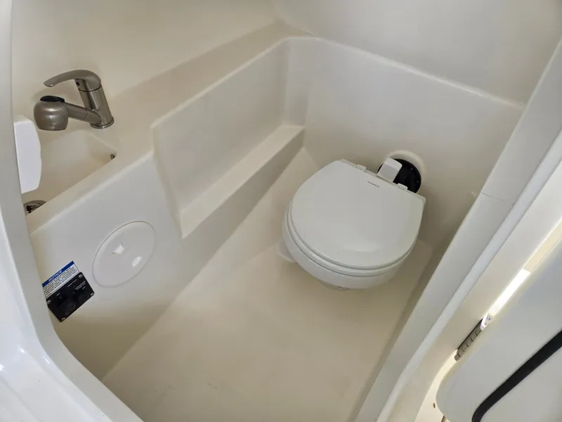 Slide: The Image of Interior of 2026 Boston Whaler 240 Vantage with toilet and sink. - 11