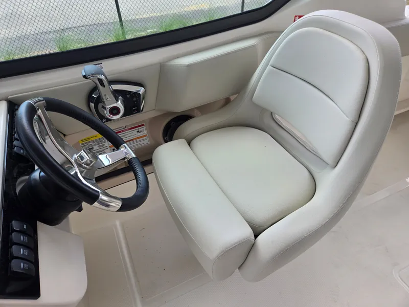 Slide: The Image of Interior of 2026 Boston Whaler 240 Vantage with steering and seat. - 13