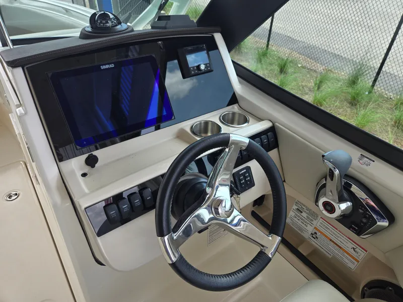 Slide: The Image of Boston Whaler 240 Vantage 2026 helm with Simrad display. - 14
