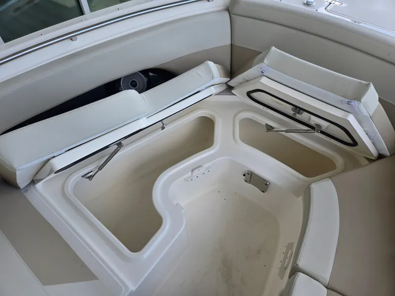 Slide: The Image of Boston Whaler 240 Vantage 2026, open storage compartment in boat. - 21