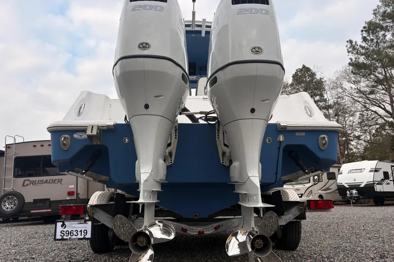 Slide: The Image of 2022 Aquasport 2500 Center Console with dual outboard engines, rear view. - 14