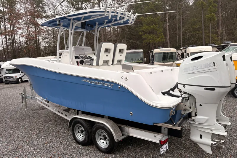 Slide: The Image of 2022 Aquasport 2500 Center Console boat with Suzuki outboard motor on trailer. - 3