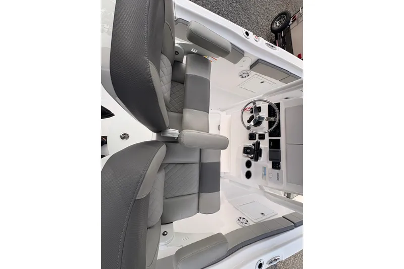 Slide: The Image of 2022 Aquasport 2500 Center Console interior with steering wheel and seating. - 6