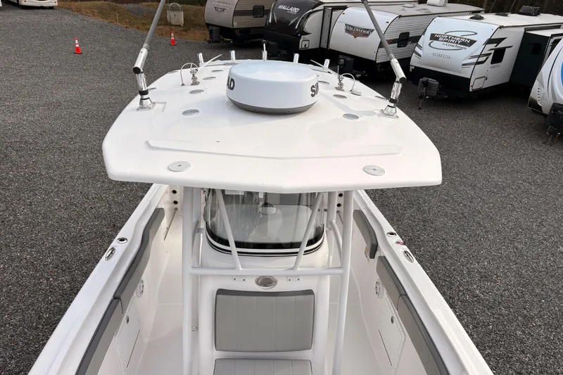 Slide: The Image of 2022 Aquasport 2500 Center Console boat, top view, parked near RVs. - 9