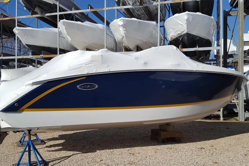 Slide: The Image of 2018 Cobalt R3 boat in storage, covered and elevated on stands. - 17