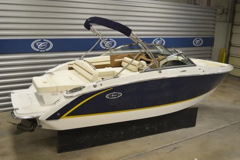 Slide: The Image of 2018 Cobalt R3 boat with blue and white exterior in showroom setting. - 7