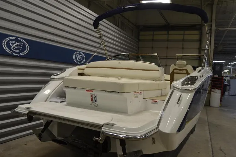 Slide: The Image of 2018 Cobalt R3 boat in a showroom, rear view with seating and logo. - 8