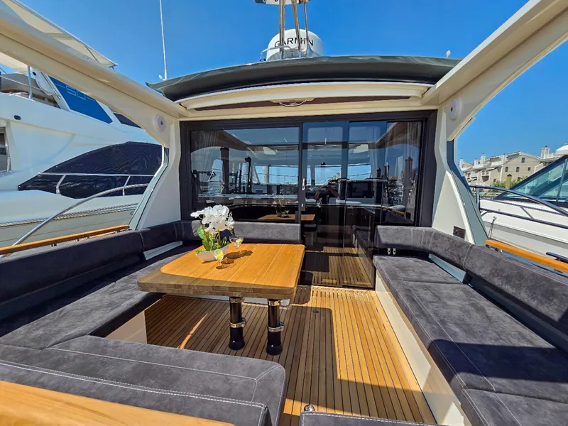 Slide: The Image of Luxurious Marex 440 yacht interior with elegant seating and wooden table, 2026 model. - 19