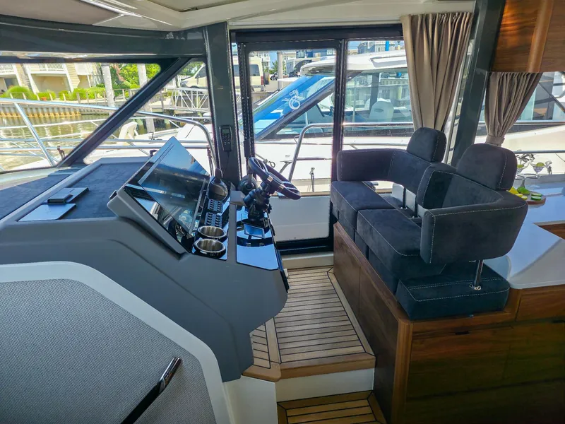 Slide: The Image of Modern Marex 440 yacht interior with sleek helm and plush seating, 2026 model. - 49
