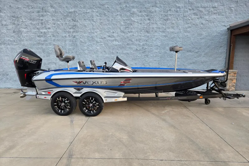 Slide: The Image of 2026 Vexus VXs20 boat on trailer, sleek design, blue and silver accents, powerful engine. - 1