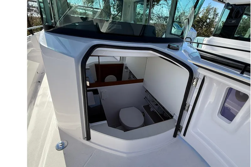 Slide: The Image of 2023 Axopar 28 Cabin boat with sleek design and spacious deck. - 16