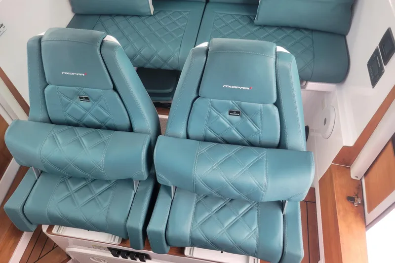 Slide: The Image of 2023 Axopar 28 Cabin dashboard with steering wheel and control panel. - 7