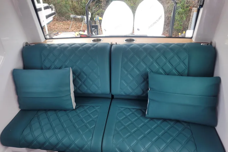 Slide: The Image of 2023 Axopar 28 Cabin interior with modern helm and comfortable seating. - 9