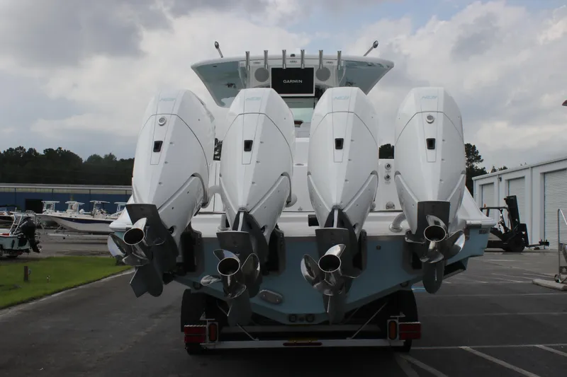 Slide: The Image of 2025 HCB Lujo boat with four powerful outboard engines, parked outdoors. - 10