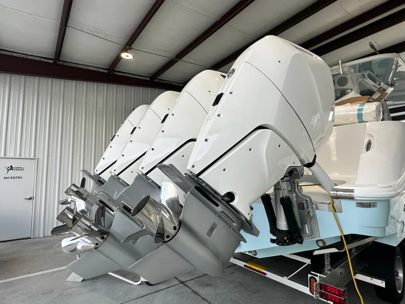 Slide: The Image of 2025 HCB Lujo boat with four powerful outboard engines in a storage facility. - 11