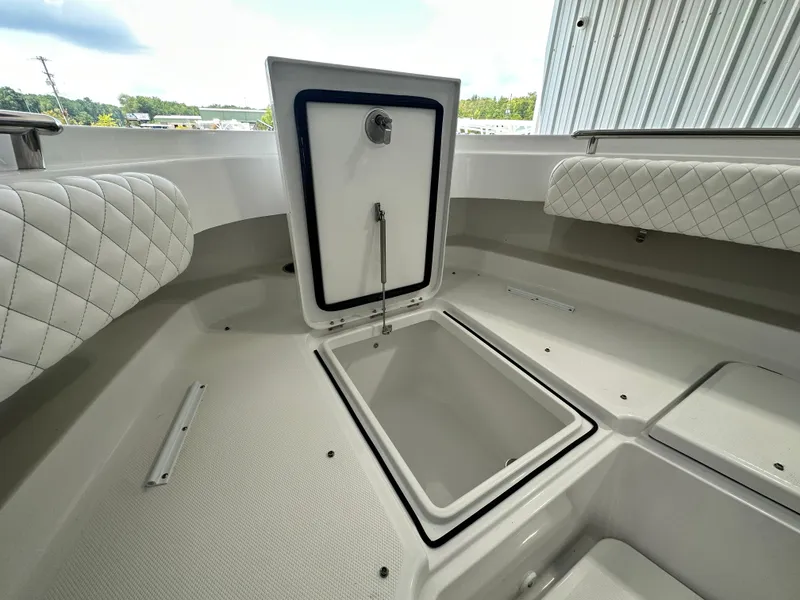 Slide: The Image of 2025 HCB Lujo boat storage compartment with open hatch, quilted seating, and sleek design. - 13