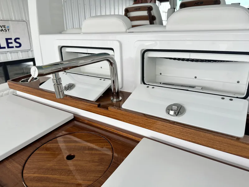 Slide: The Image of 2025 HCB Lujo yacht interior with sleek kitchen sink and wooden countertop. - 19