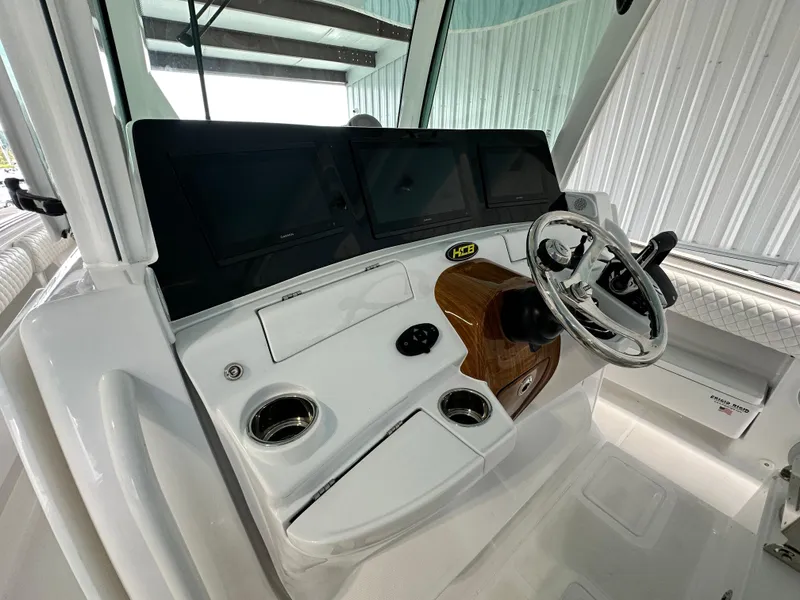 Slide: The Image of 2025 HCB Lujo boat helm with modern controls and steering wheel. - 29
