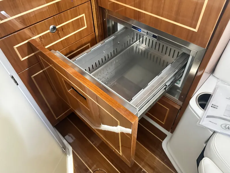 Slide: The Image of 2025 HCB Lujo yacht interior with open wooden drawer and stainless steel insert. - 32