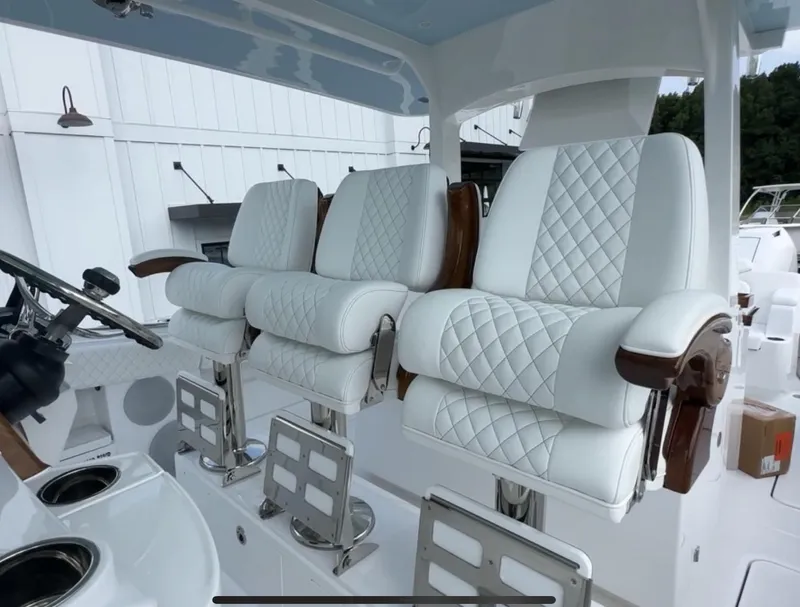 Slide: The Image of Luxurious white leather seats on 2025 HCB Lujo boat, featuring elegant diamond stitching. - 36