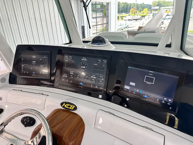 Slide: The Image of HCB Lujo 2025 boat dashboard with advanced navigation screens and controls. - 46