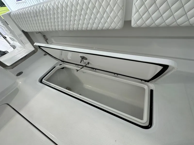 Slide: The Image of 2025 HCB Lujo boat with open storage compartment and quilted seating. - 49