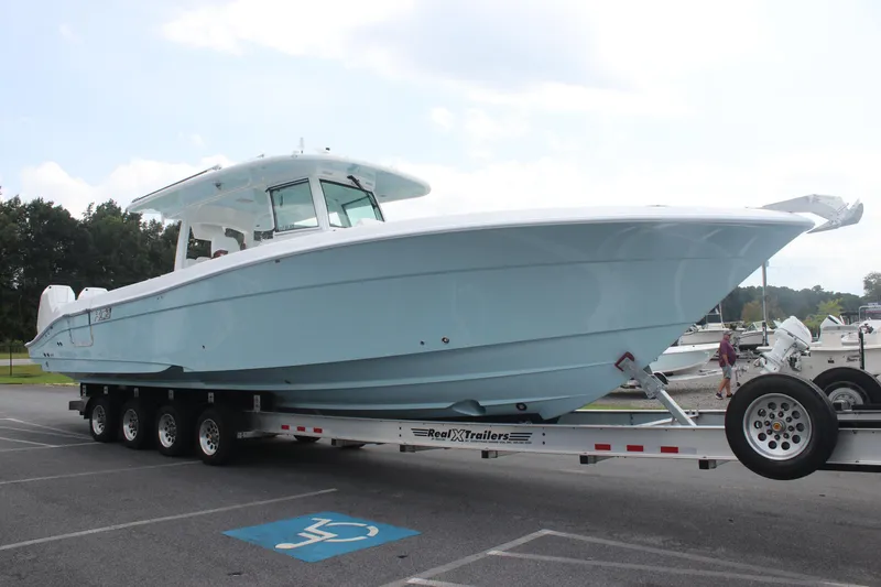 Slide: The Image of 2025 HCB Lujo boat on trailer in parking lot. - 5