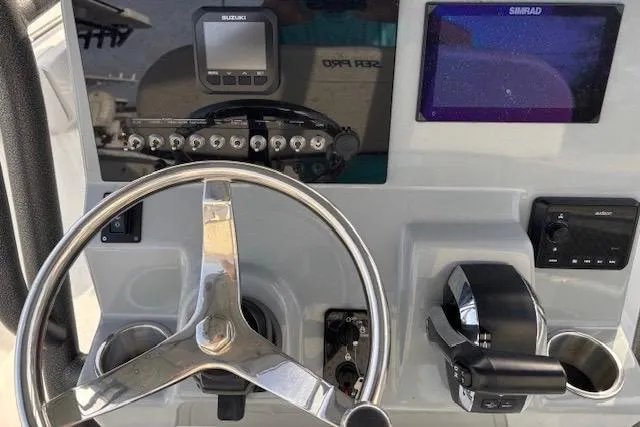 Slide: The Image of 2025 Sea Pro 225FLX Sandbar boat dashboard with steering wheel and control panel. - 5