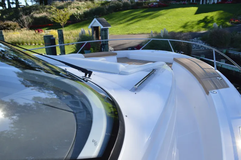 Slide: The Image of 2024 Tiara Yachts EX 60 deck with sleek design and scenic background. - 10